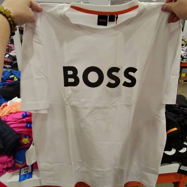 At Costco, clothing from well-known brands sits on tables, not on hangers.
